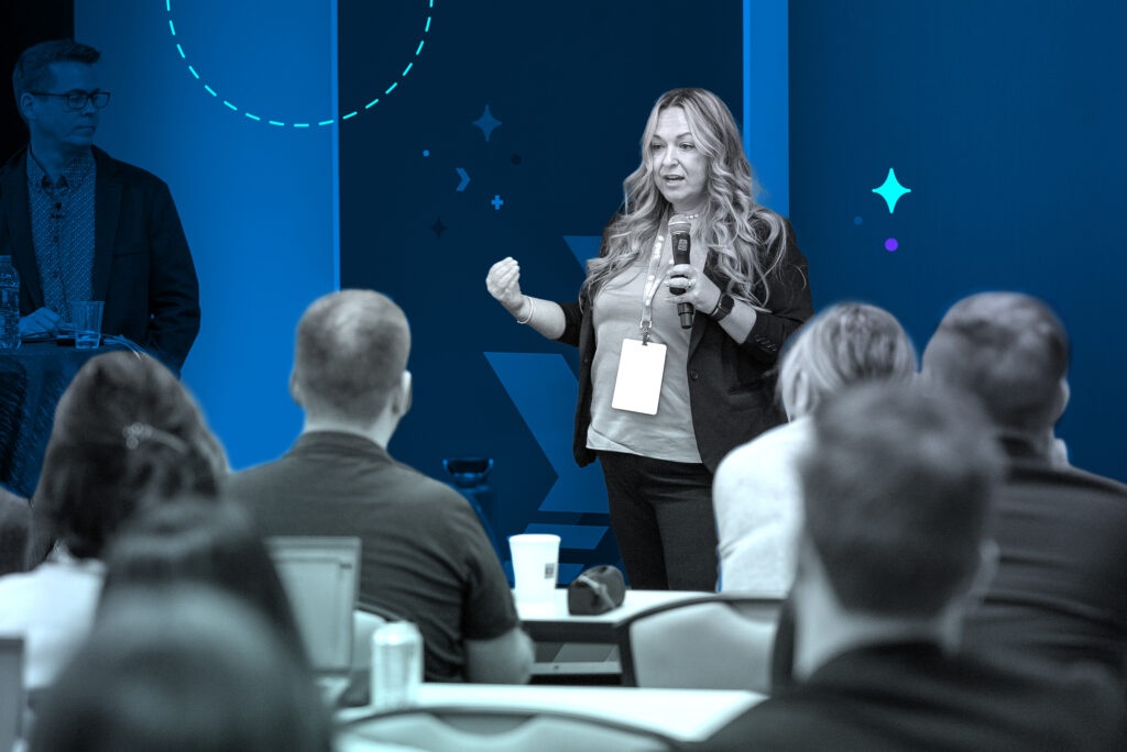 Presenter speaks to group at Spark event